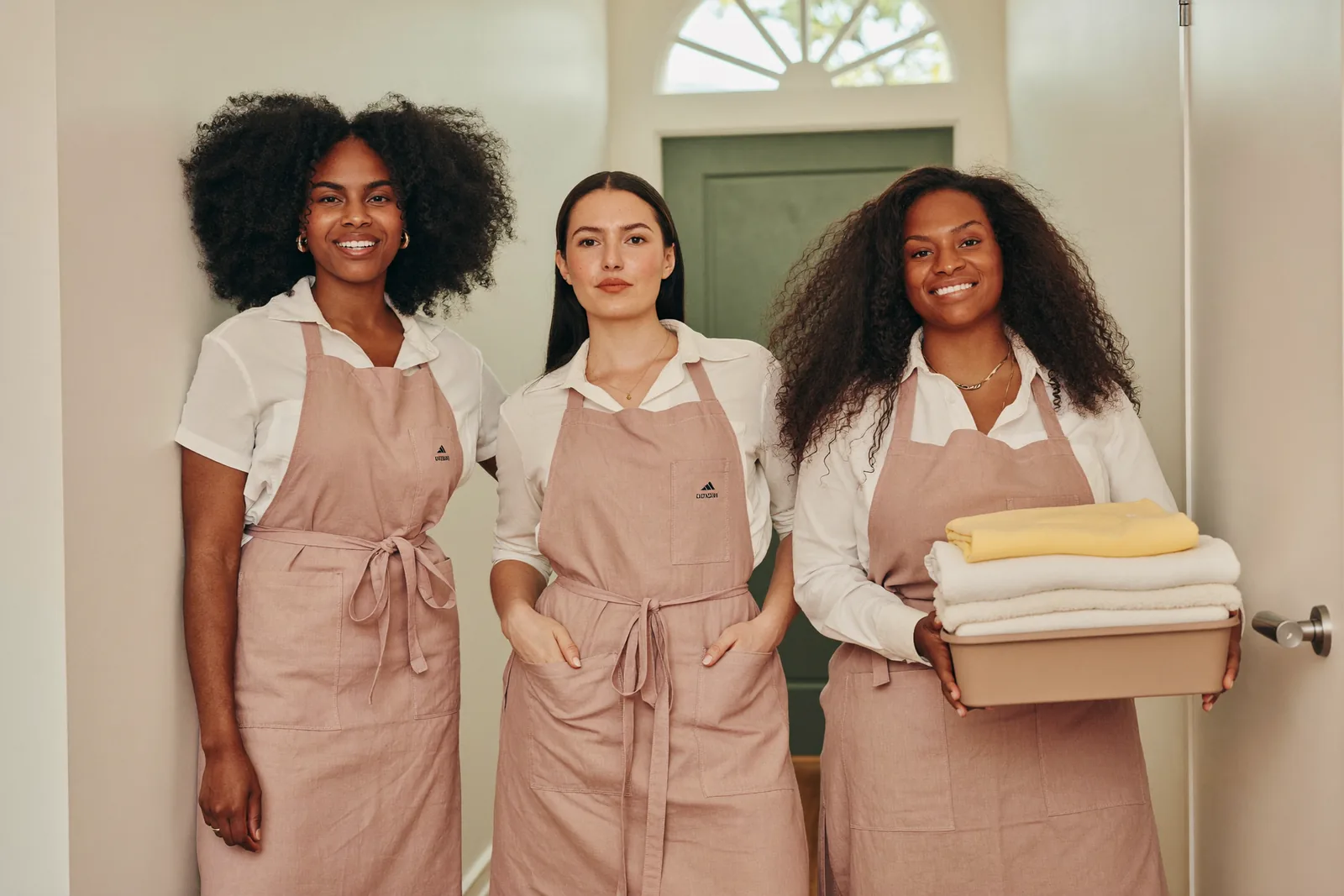 Three Pink Planett housekeepers in the hallway of a London home